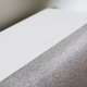 The top of the speaker is touch sensitive. Touch the middle to play or pause. Slide on either side to adjust volume.